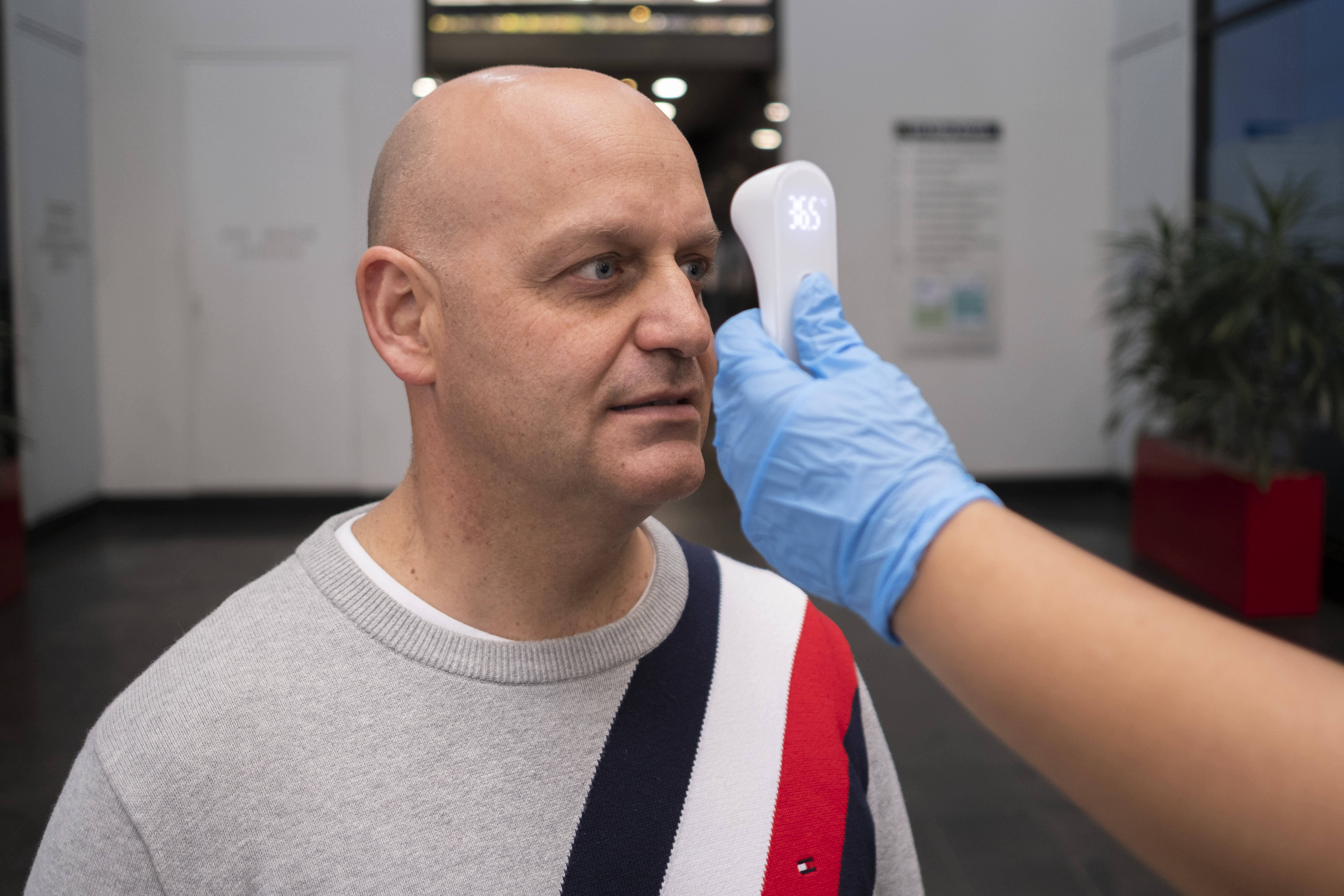 Man getting temperature screened at the office 