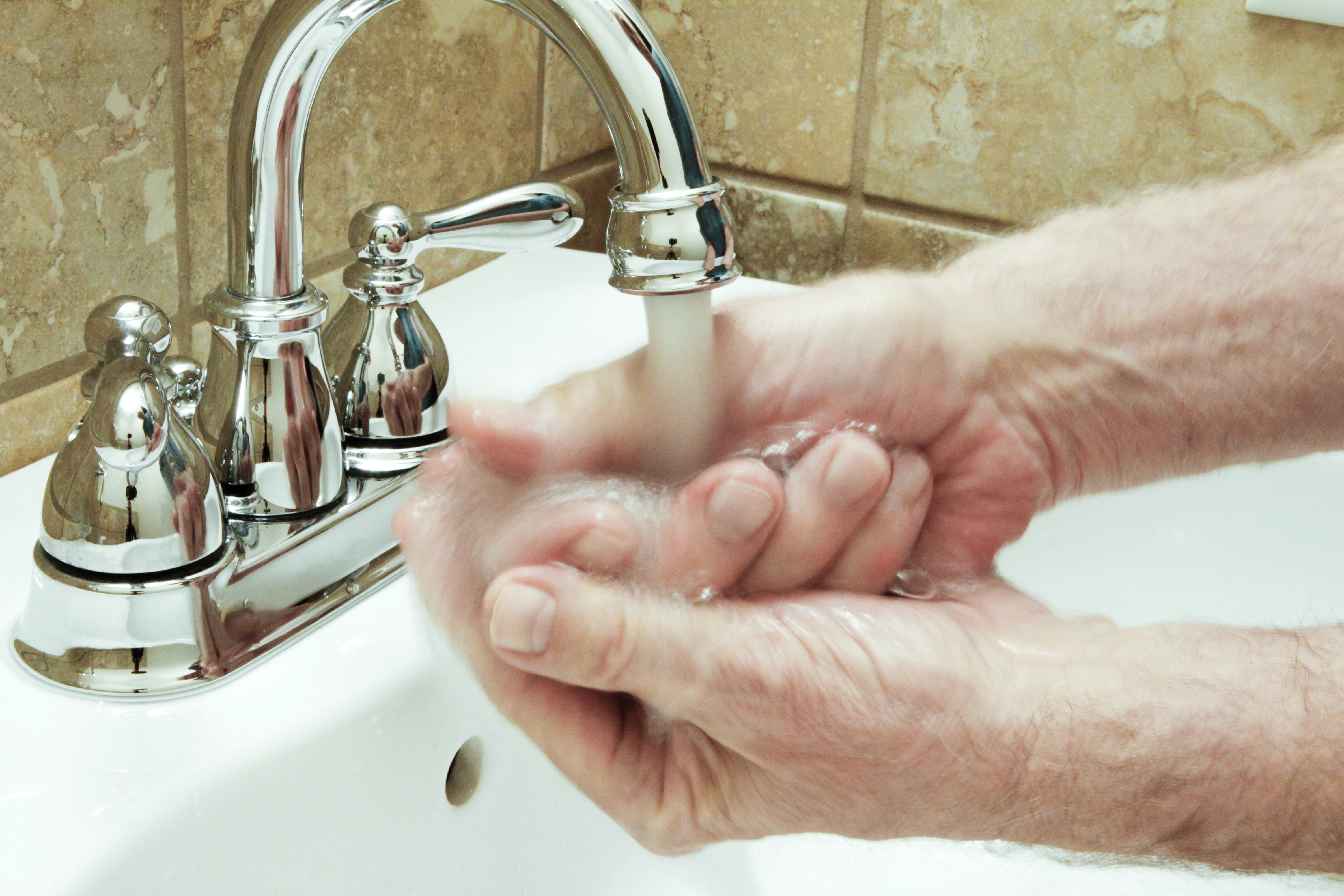 Person washing hands with soap