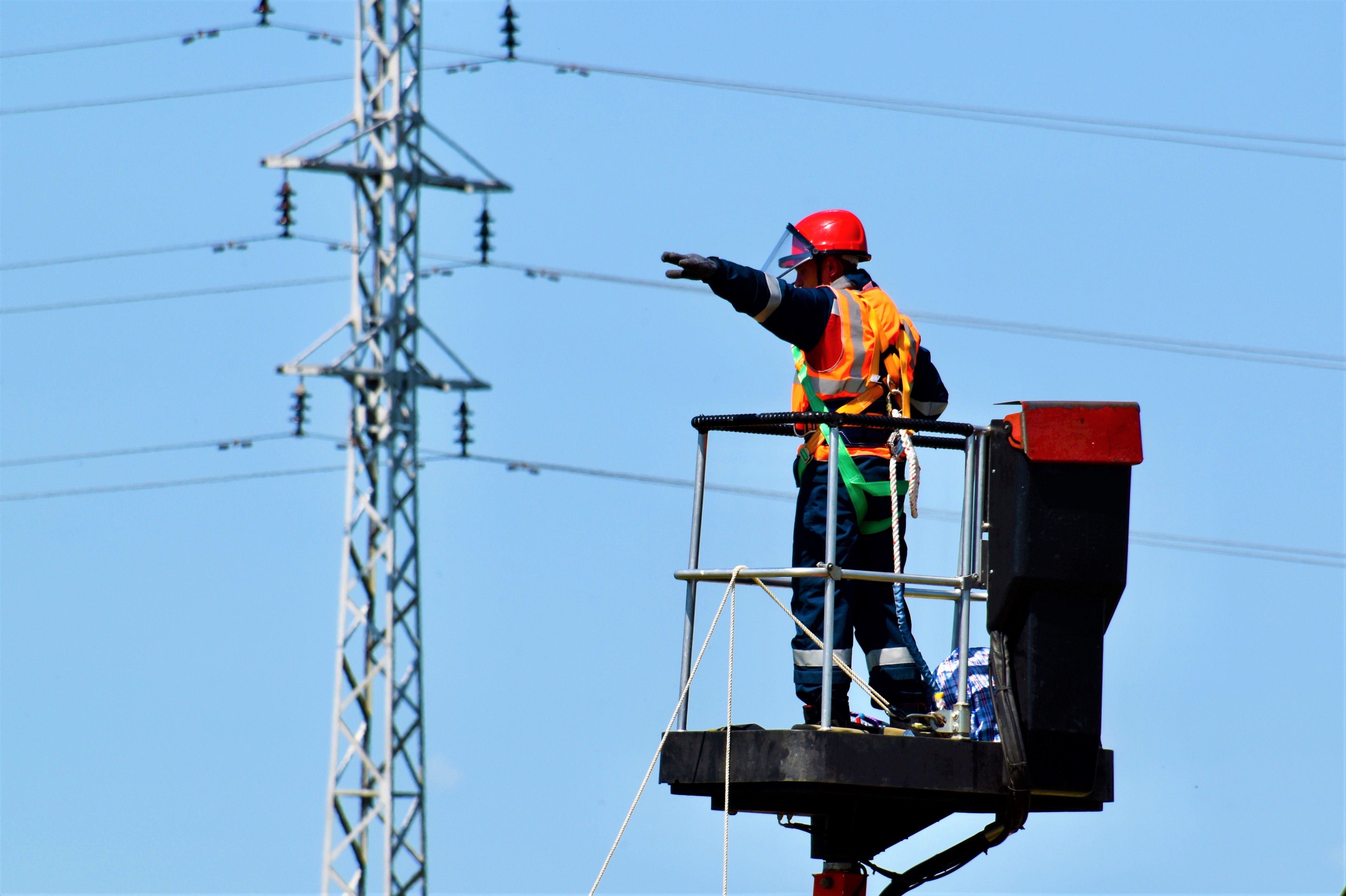 Electrical worker on a crane directing movement