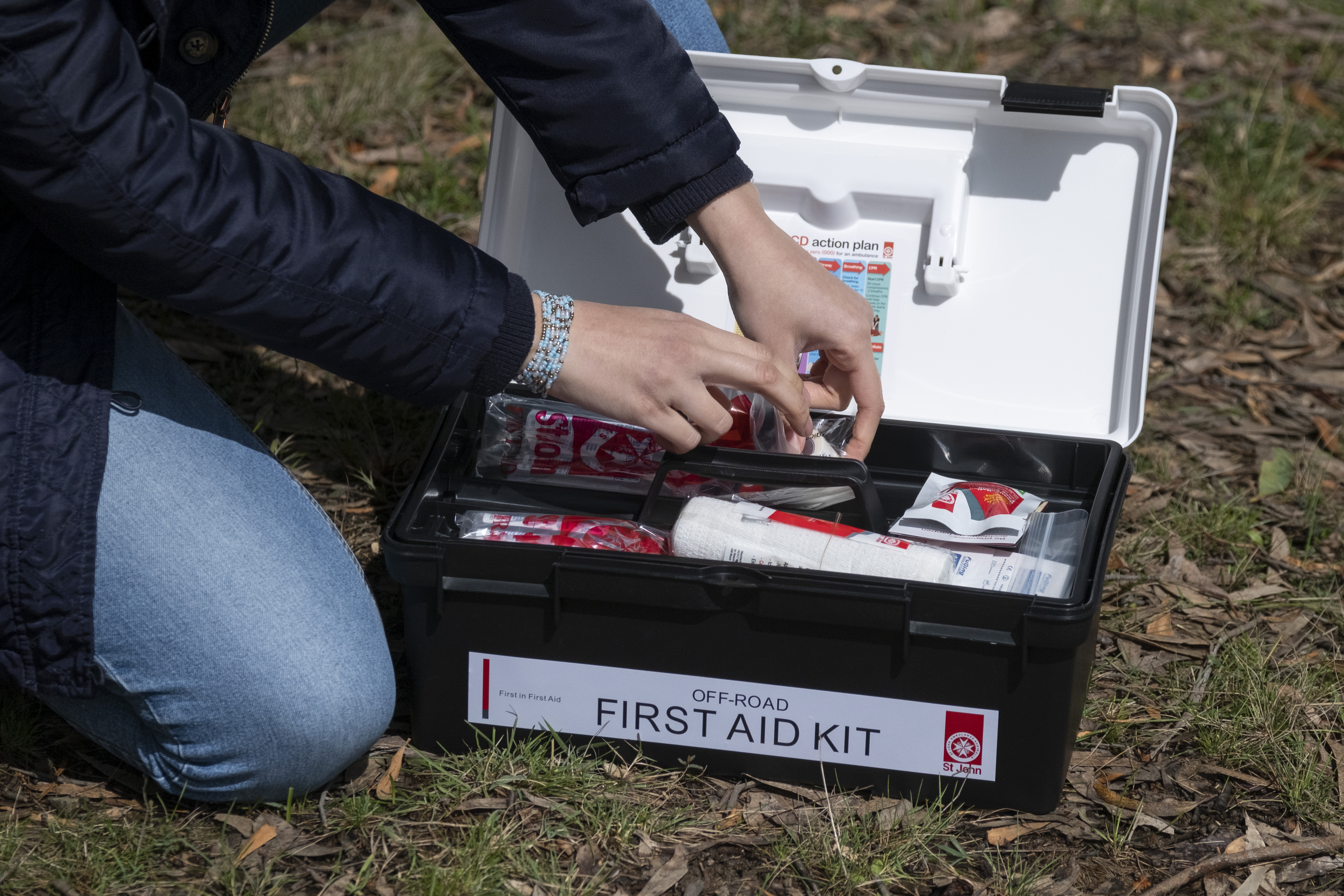 person looking through St John First Aid Kit